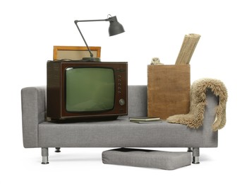 Photo of Soft sofa, retro TV set and other used stuff isolated on white