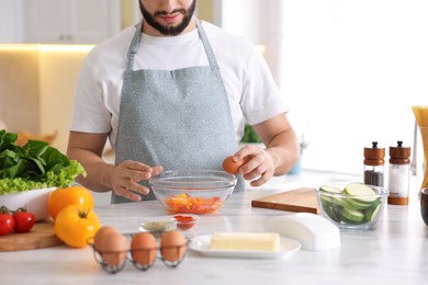 Photo of Man cooking at marble table indoors, closeup