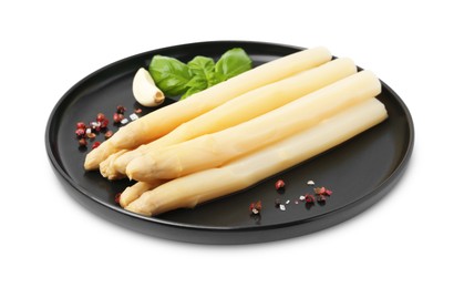 Photo of Spears of pickled asparagus with spices isolated on white