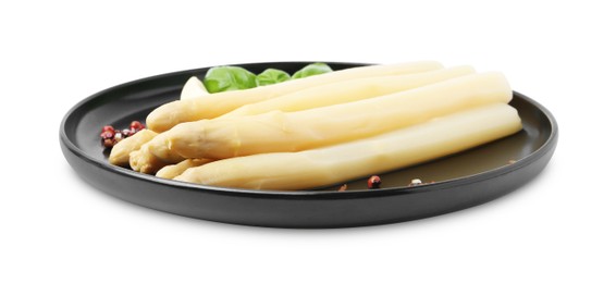 Photo of Spears of pickled asparagus with spices isolated on white