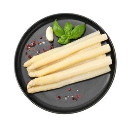 Photo of Spears of pickled asparagus with spices isolated on white, top view