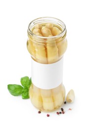 Photo of Pickled asparagus in jar and spices isolated on white