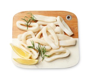 Photo of Uncooked squid rings with lemon slices and rosemary isolated on white, top view