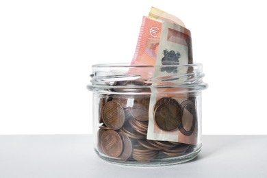 Photo of Glass jar with money isolated on white