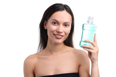 Photo of Smiling young woman with bottle of mouthwash on white background. Oral hygiene