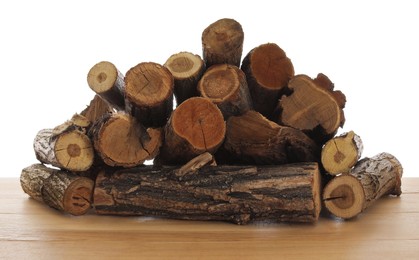 Photo of Pile of cut firewood on wooden table against white background