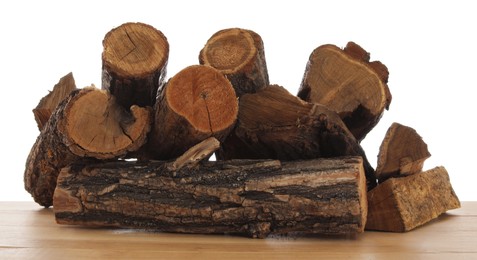 Photo of Pile of cut firewood on wooden table against white background