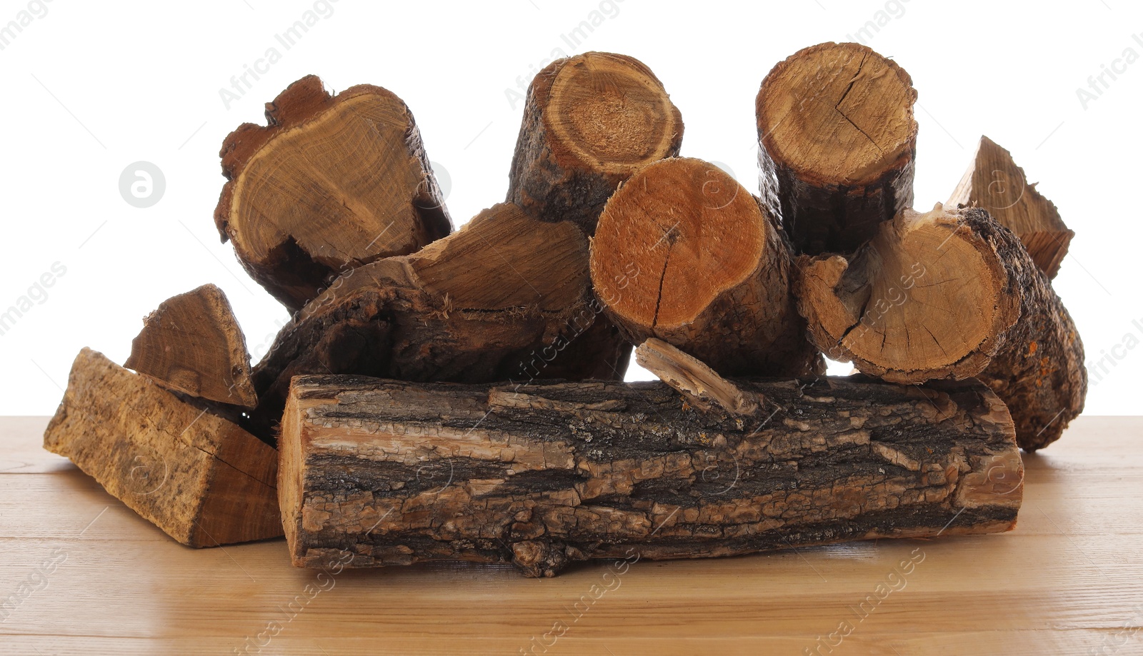 Photo of Pile of cut firewood on wooden table against white background
