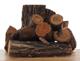 Photo of Pile of cut firewood on wooden table against white background