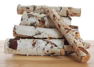 Photo of Pile of cut firewood on wooden table against white background