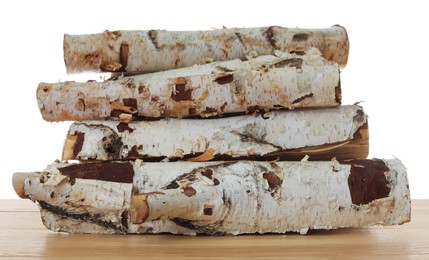 Photo of Pile of cut firewood on wooden table against white background