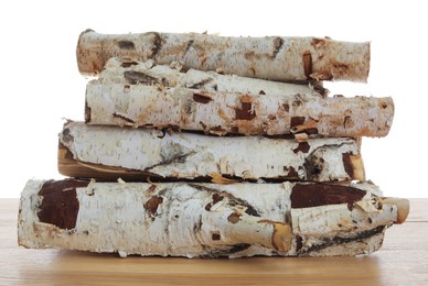Photo of Pile of cut firewood on wooden table against white background