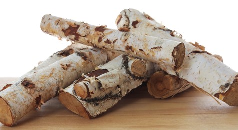 Photo of Pile of cut firewood on wooden table against white background