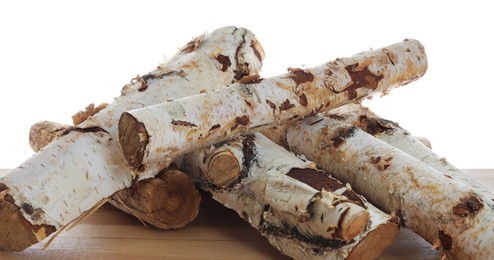 Photo of Pile of cut firewood on wooden table against white background