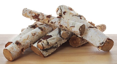 Photo of Pile of cut firewood on wooden table against white background