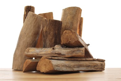 Photo of Pile of cut firewood on wooden table against white background