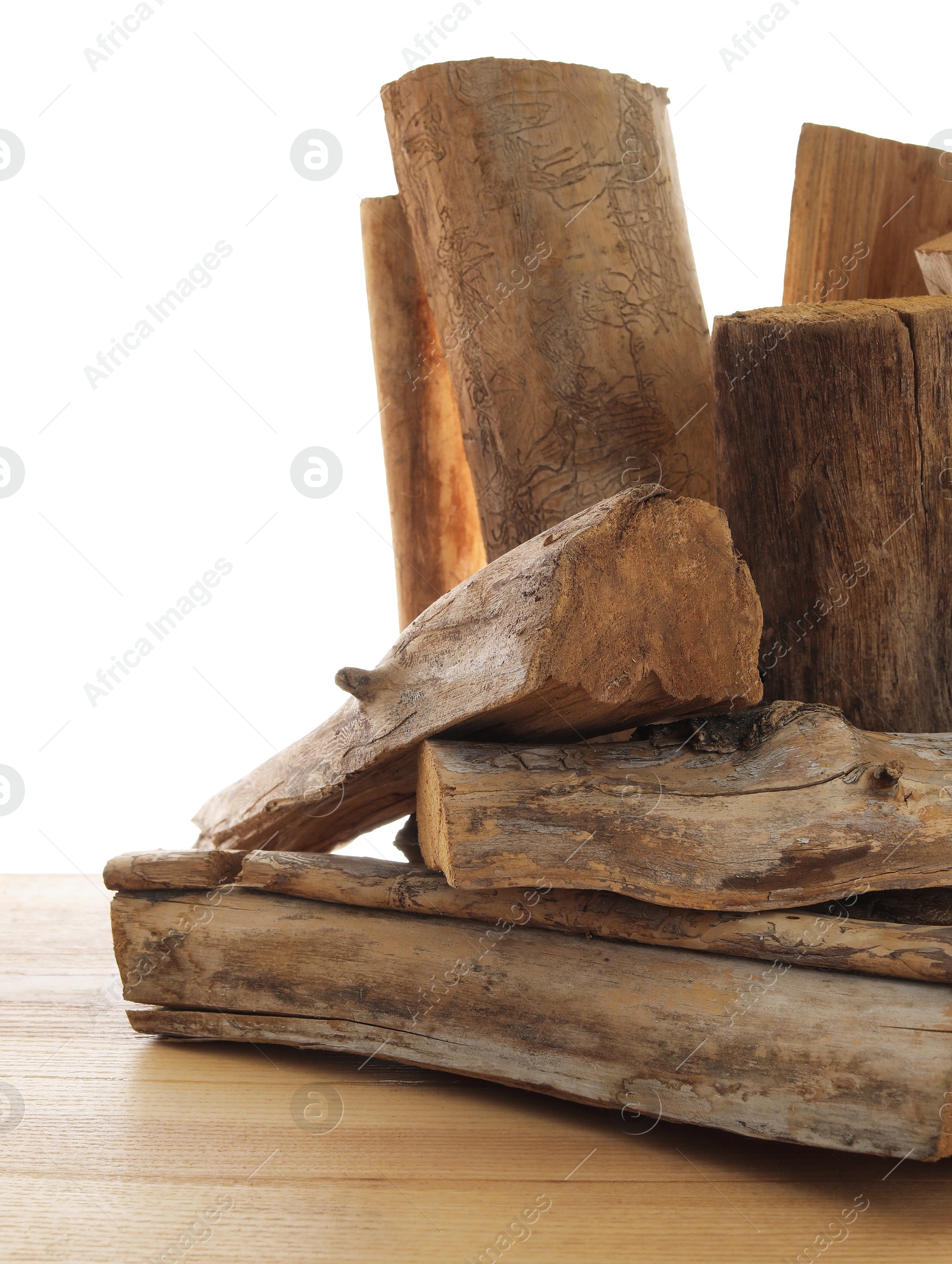 Photo of Pile of cut firewood on wooden table against white background
