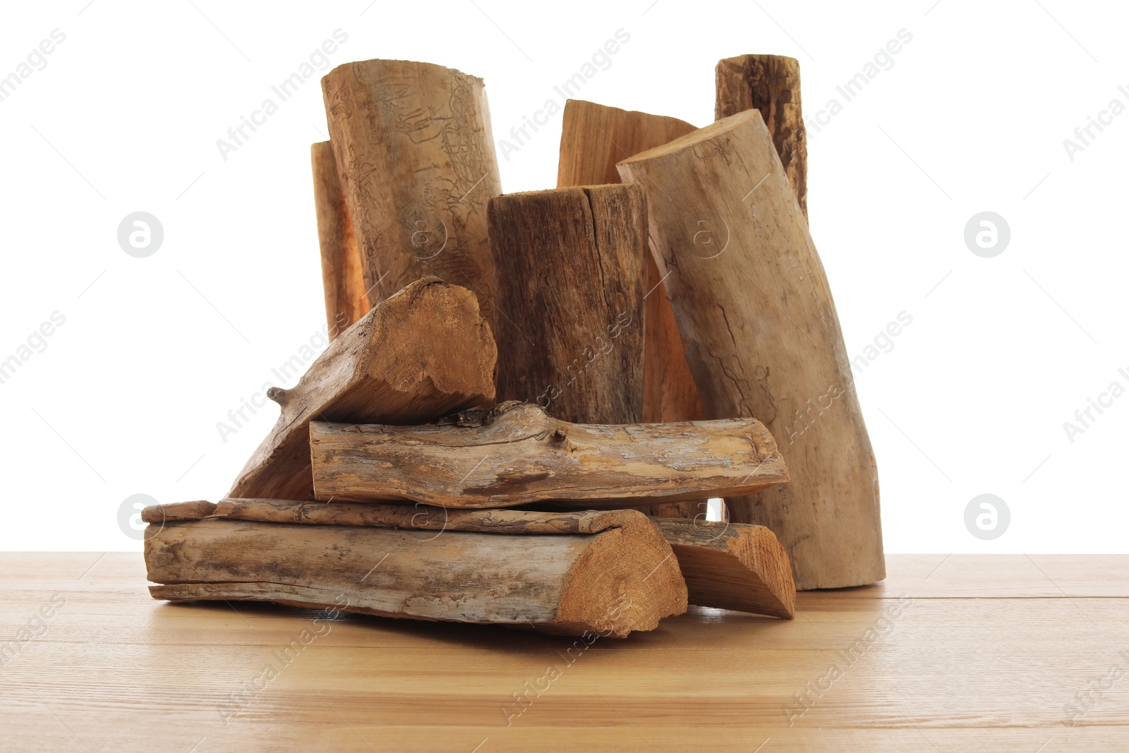 Photo of Pile of cut firewood on wooden table against white background