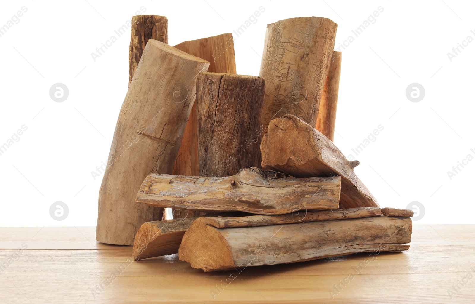 Photo of Pile of cut firewood on wooden table against white background