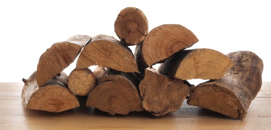 Photo of Pile of cut firewood on wooden table against white background
