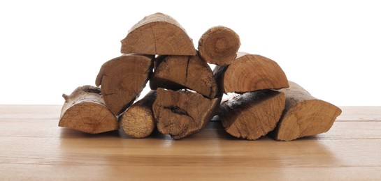 Photo of Pile of cut firewood on wooden table against white background
