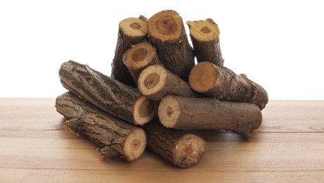 Photo of Pile of cut firewood on wooden table against white background