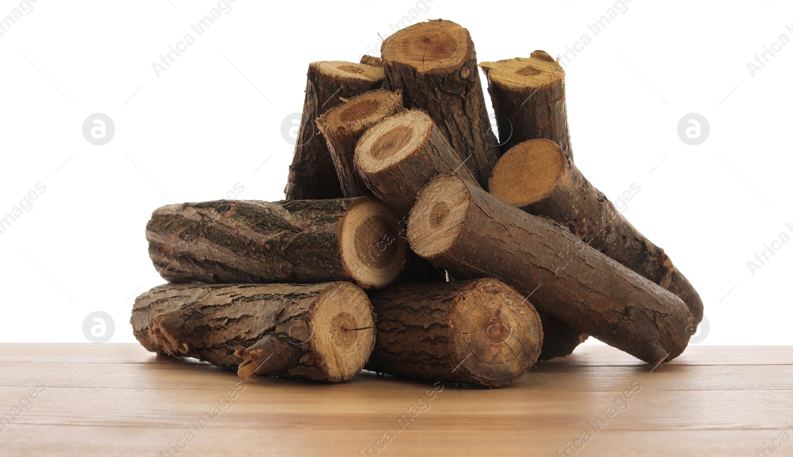Photo of Pile of cut firewood on wooden table against white background
