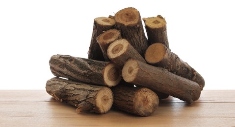 Photo of Pile of cut firewood on wooden table against white background