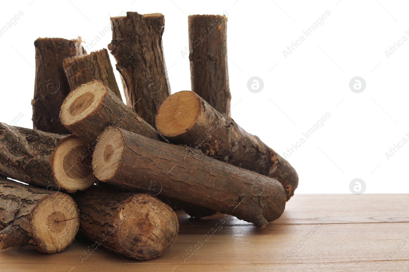 Photo of Pile of cut firewood on wooden table against white background
