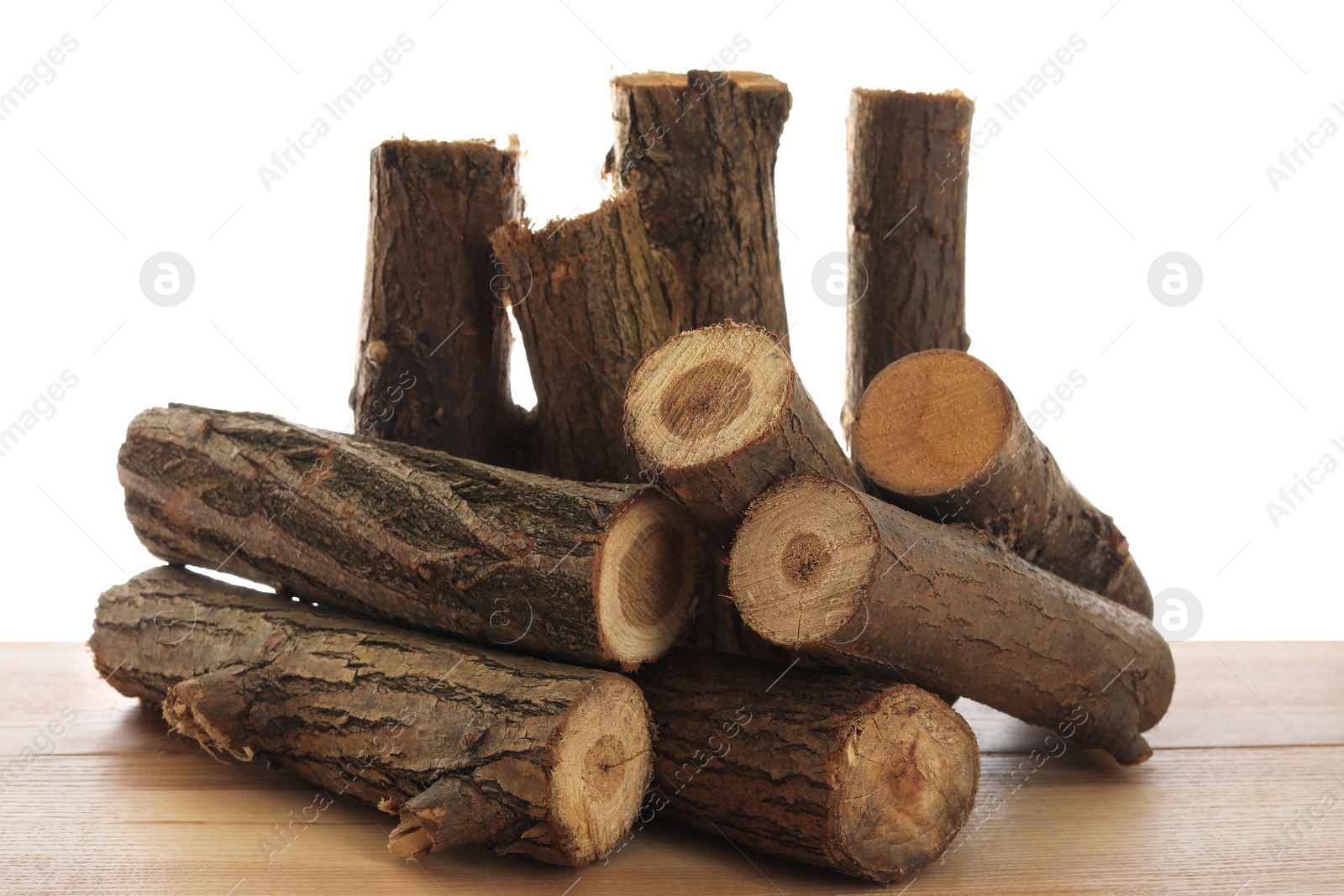 Photo of Pile of cut firewood on wooden table against white background