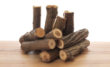 Photo of Pile of cut firewood on wooden table against white background
