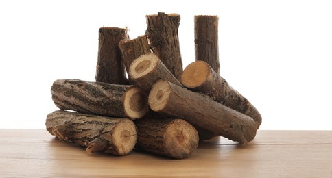 Photo of Pile of cut firewood on wooden table against white background