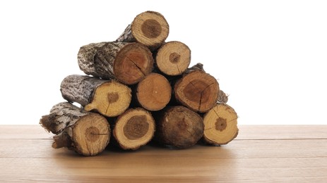 Photo of Pile of cut firewood on wooden table against white background