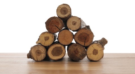 Photo of Pile of cut firewood on wooden table against white background