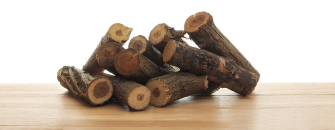 Photo of Pile of cut firewood on wooden table against white background