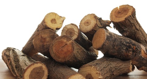 Photo of Pile of cut firewood on wooden table against white background