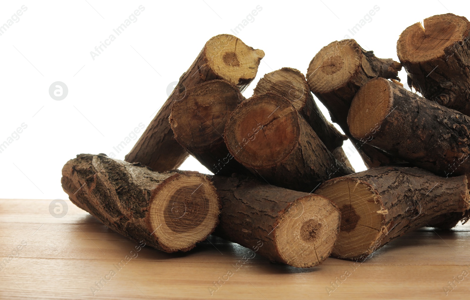 Photo of Pile of cut firewood on wooden table against white background