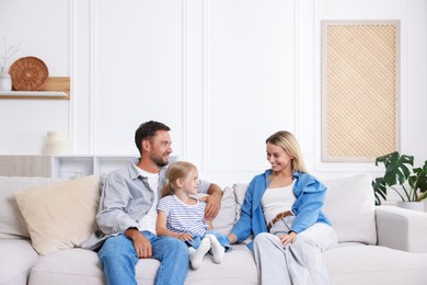 Photo of Happy family spending time together on sofa at home