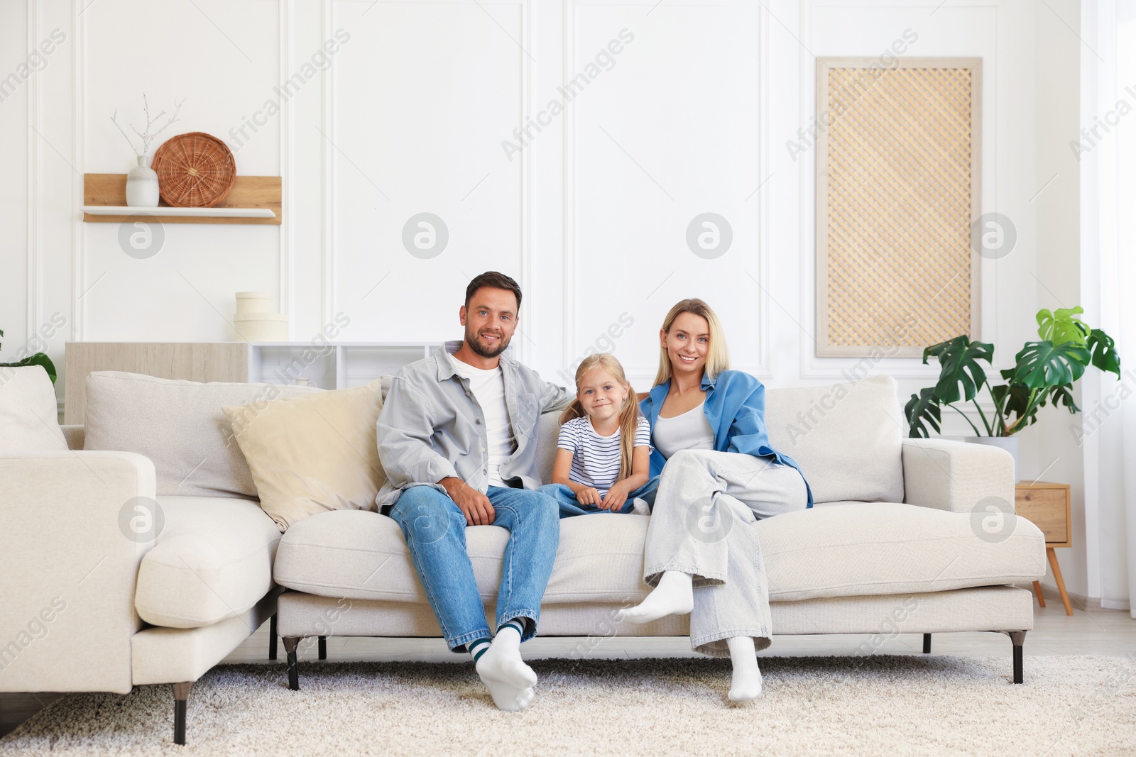 Photo of Happy family spending time together on sofa at home