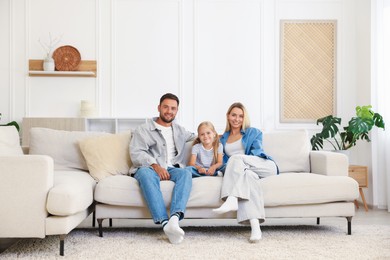 Photo of Happy family spending time together on sofa at home