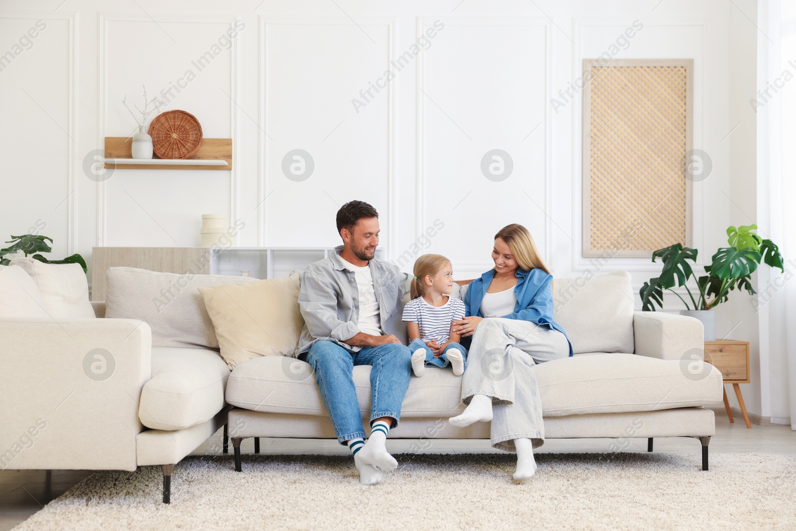 Photo of Happy family spending time together on sofa at home