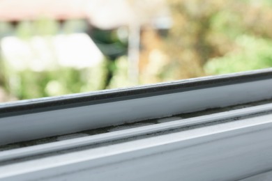 Photo of Window frame covered with dust indoors, closeup