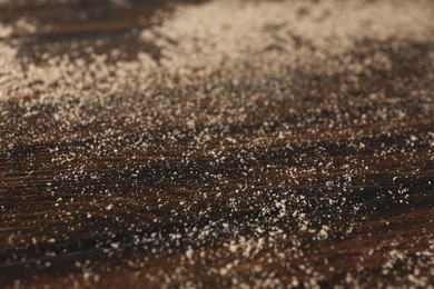 Photo of Wooden table covered with dust, closeup view