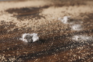 Photo of Wooden table covered with dust, closeup view