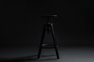 Photo of Bar stool on black background. Used stuff