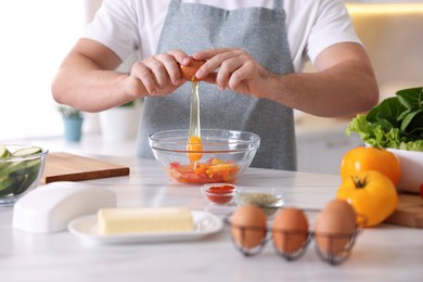 Photo of Man cooking at marble table indoors, closeup