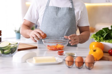 Photo of Man cooking at marble table indoors, closeup
