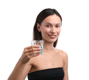 Photo of Young woman with glass of mouthwash on white background. Oral hygiene