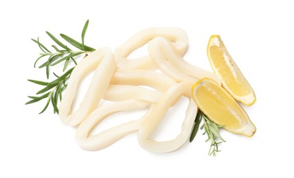 Photo of Uncooked squid rings with lemon slices and rosemary isolated on white, top view