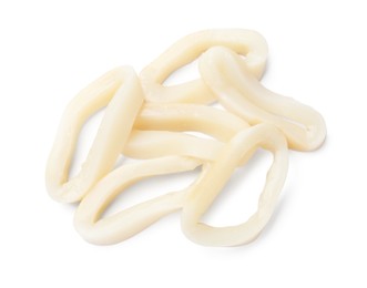 Photo of Many uncooked squid rings isolated on white, top view